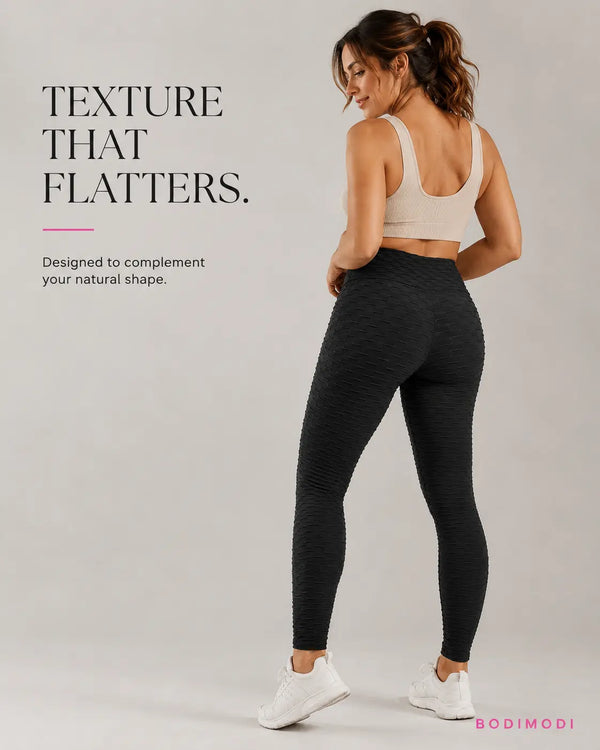 Woman wearing black BodiModi HoneyComb anti-cellulite leggings with high-waist textured fit